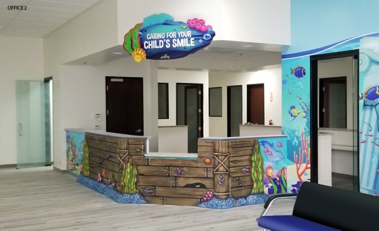 Reception desk outfitted with an underwater themed mural, 3D cladded siding, and themed signage.