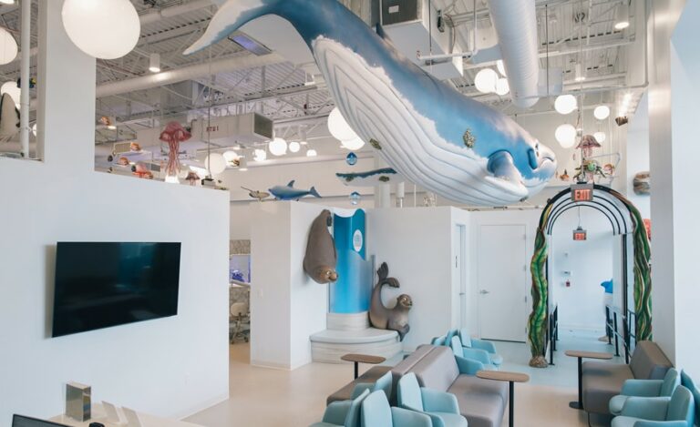 Underwater themed waiting room with giant overhanging whale, photo op corner with seals.