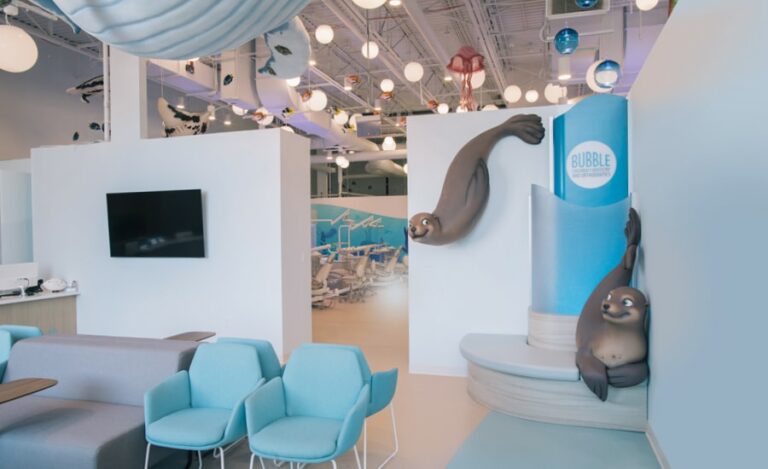 Waiting area with themed photo op corner seating with two smiley seals posing for pictures.