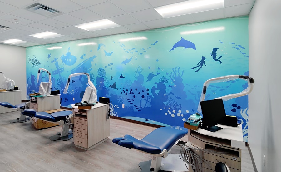 Contemporary silhouette underwater themed wall mural in a dental treatment bay.