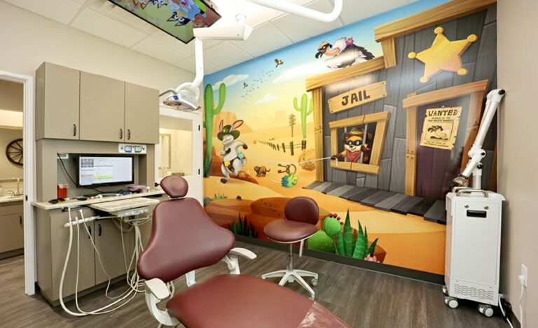 Dental treatment room with a western themed wall mural.
