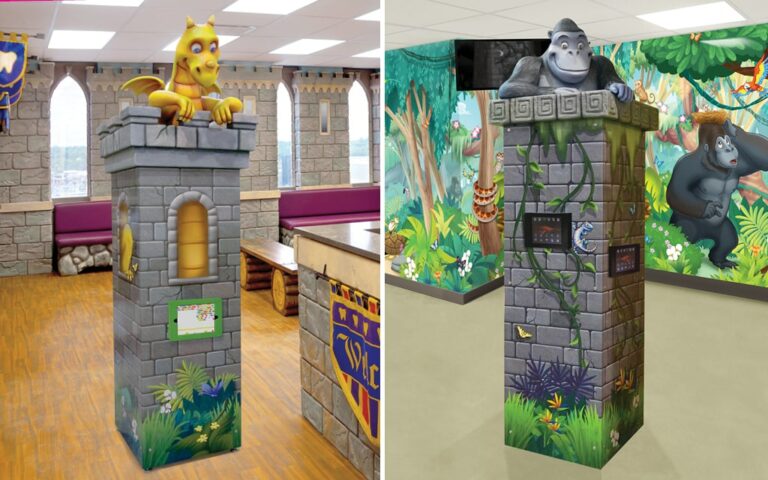 Gaming towers with tablet games, graphics, and a sculpted character on top.