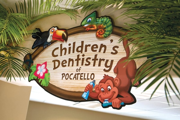 Jungle themed sign reading "Children's Dentistry of Pocatello".
