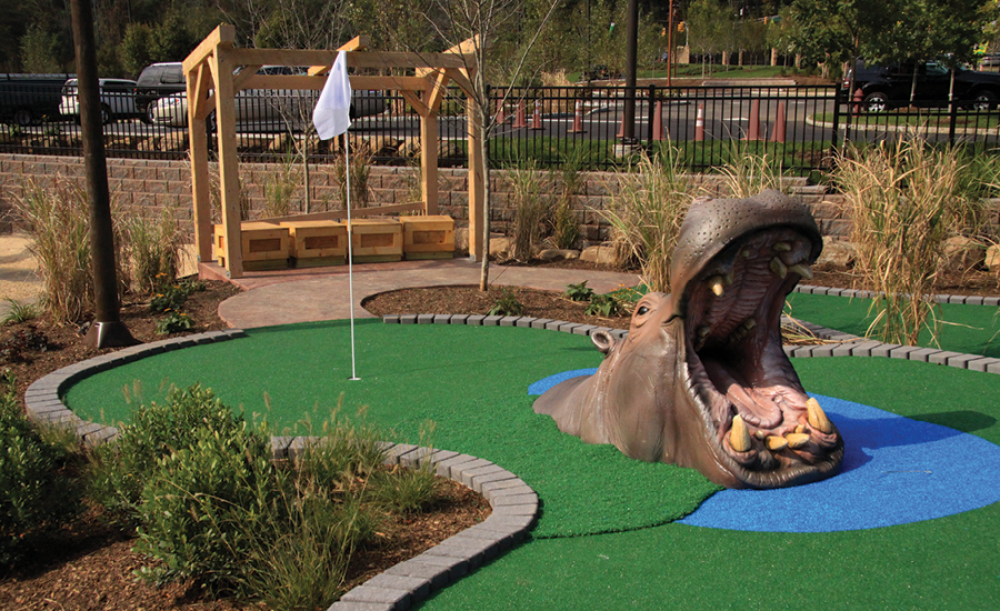 Sculpted open-mouthed hippo character for outdoor mini golf course.