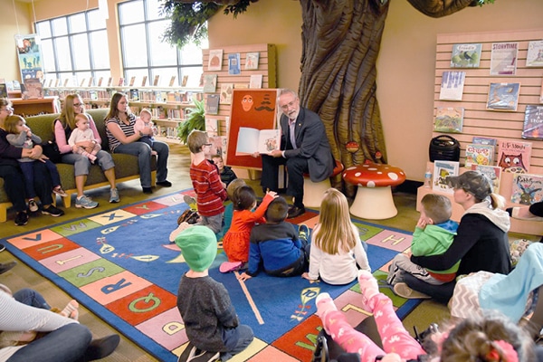 Library story time area with sculpted tree.